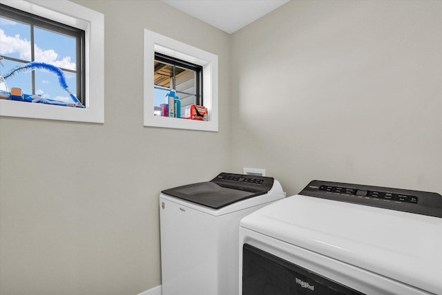 laundry area with laundry area, baseboards, and washer and dryer