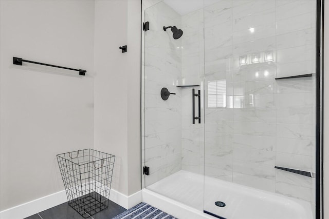 bathroom featuring a stall shower and baseboards