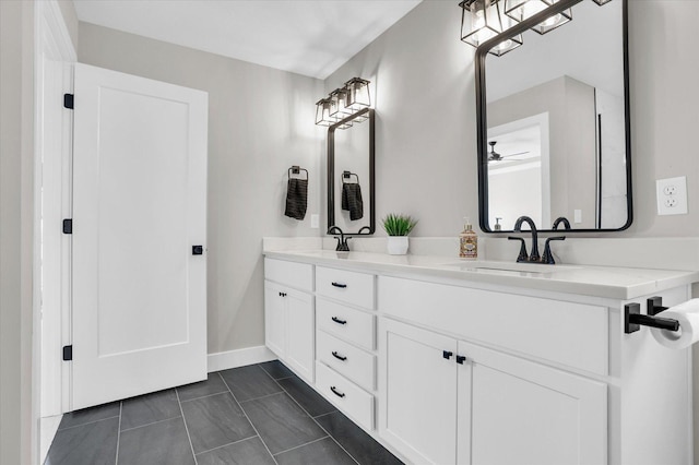 full bathroom featuring ceiling fan, a sink, baseboards, and double vanity