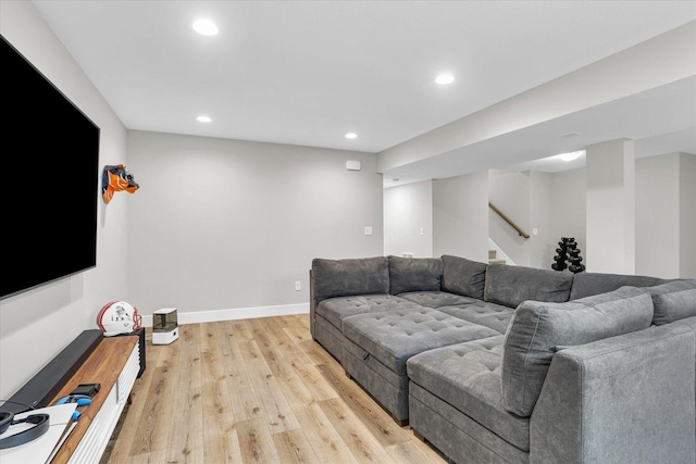 living area with baseboards, stairway, light wood-style flooring, and recessed lighting