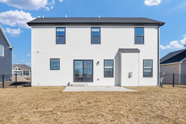 rear view of property featuring fence, a lawn, and a patio