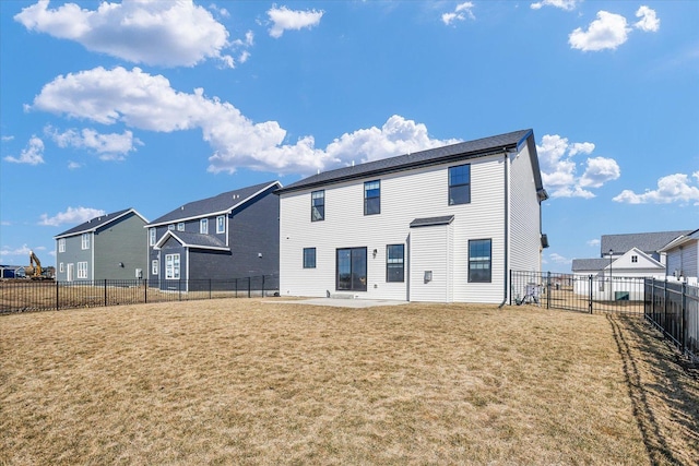 back of house with a patio area, a fenced backyard, a residential view, and a lawn