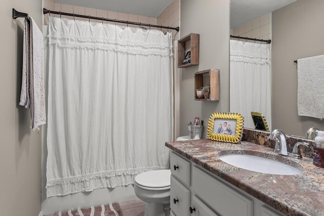 full bath featuring toilet, shower / bath combination with curtain, and vanity