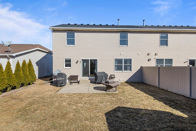 rear view of house featuring a yard, a patio, and fence