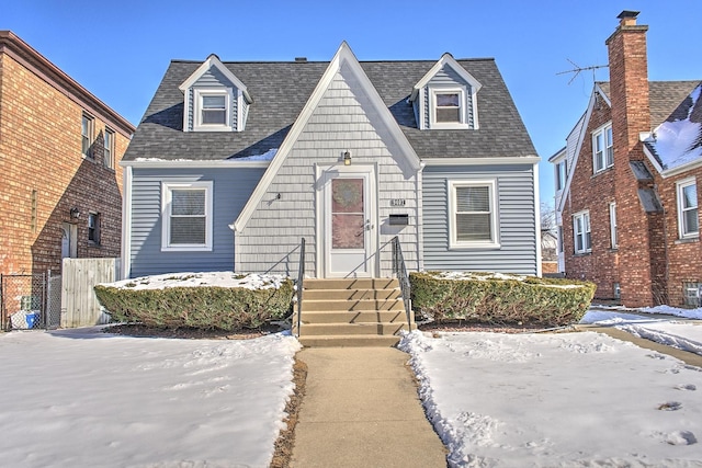 view of front of property featuring a shingled roof and fence