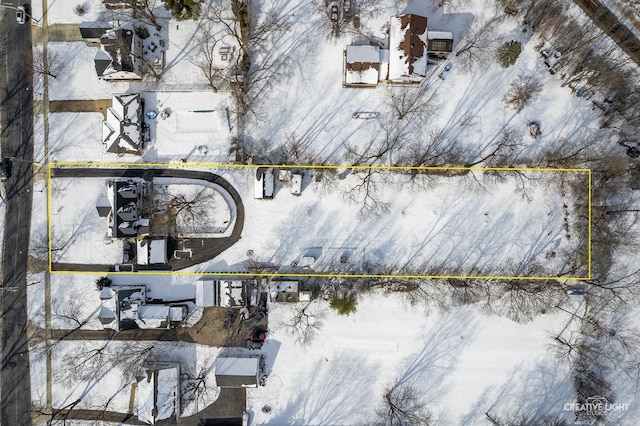 snowy aerial view with a residential view