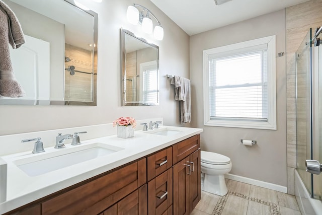 bathroom featuring a sink, toilet, and a healthy amount of sunlight