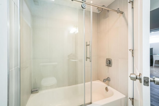 bathroom featuring combined bath / shower with glass door