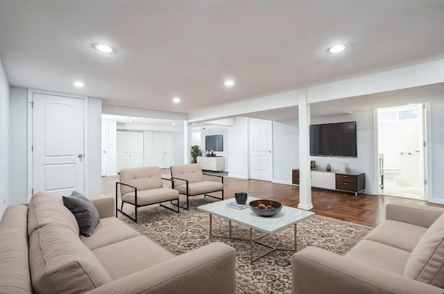 living area with parquet floors, baseboards, and recessed lighting