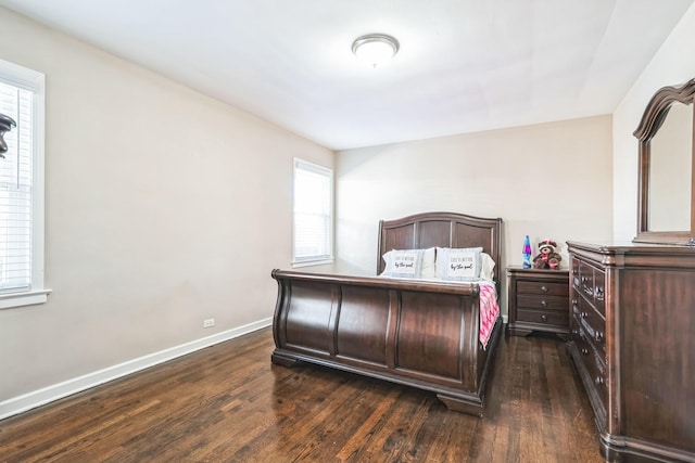 bedroom with dark wood-style flooring and baseboards