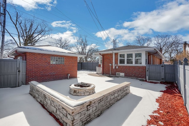 view of patio with an outdoor fire pit, a gate, and fence