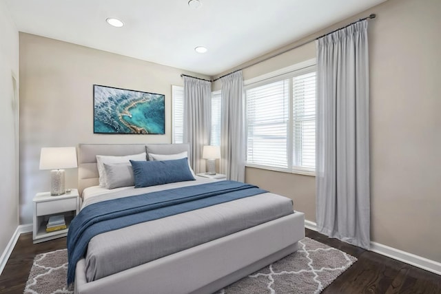 bedroom with recessed lighting, dark wood finished floors, and baseboards