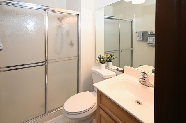 full bath featuring a stall shower, vanity, and toilet