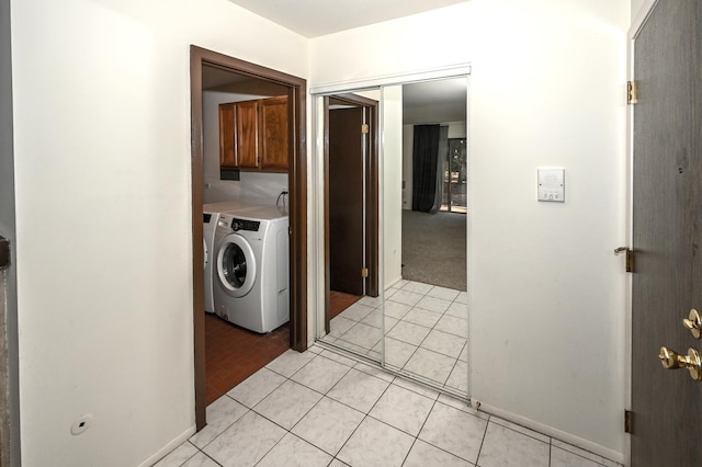 laundry room with cabinet space and light tile patterned floors