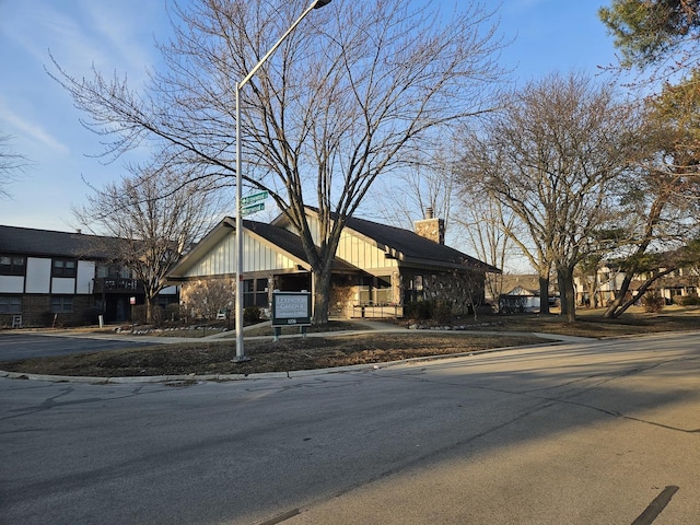 view of front of property with a chimney and board and batten siding