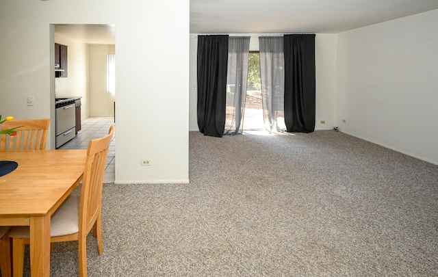 dining space featuring light carpet and plenty of natural light