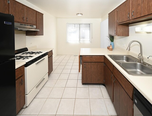 kitchen featuring dishwashing machine, freestanding refrigerator, white gas range, under cabinet range hood, and a sink