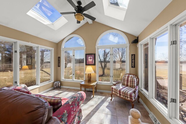 sunroom featuring visible vents, vaulted ceiling with skylight, and ceiling fan