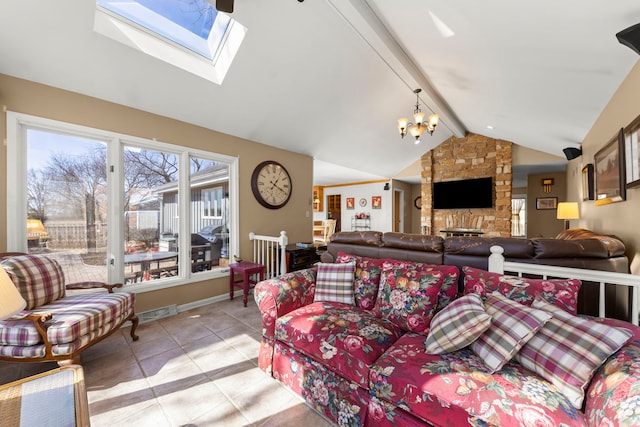 living area with visible vents, a notable chandelier, vaulted ceiling with skylight, light tile patterned floors, and baseboards