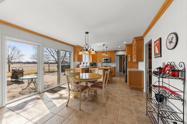 dining space with light tile patterned floors, a chandelier, recessed lighting, and ornamental molding