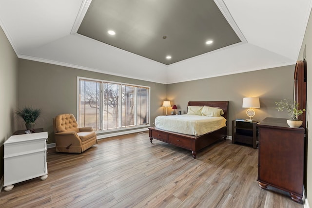 bedroom featuring recessed lighting, a raised ceiling, light wood-style flooring, and crown molding