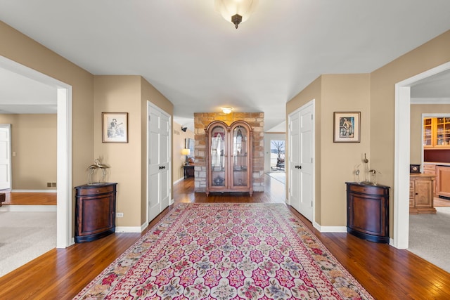 entryway featuring visible vents, baseboards, and hardwood / wood-style flooring