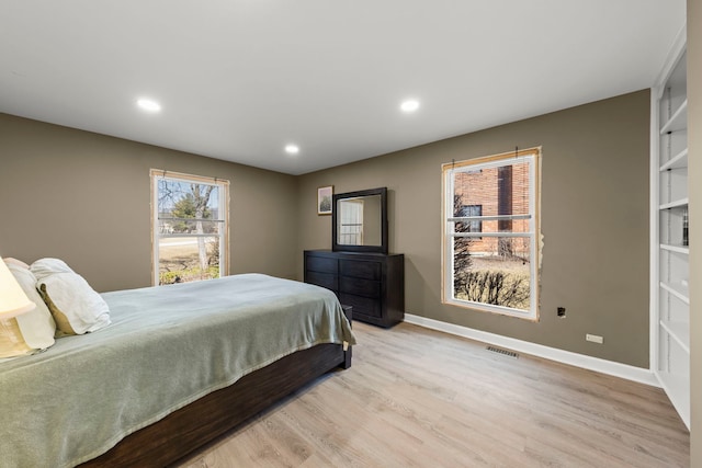 bedroom with recessed lighting, visible vents, baseboards, and light wood-style flooring