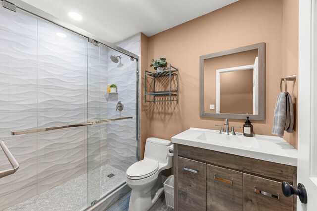 full bathroom featuring vanity, toilet, and a stall shower