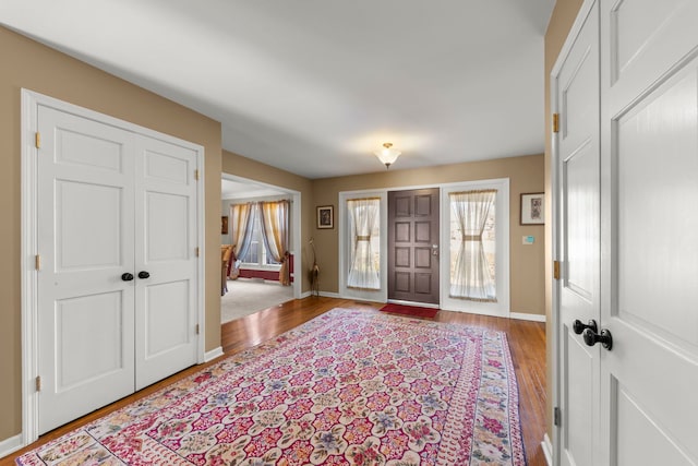 foyer featuring wood finished floors and baseboards