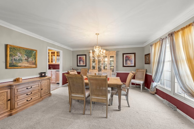 dining area featuring light carpet, a chandelier, and ornamental molding