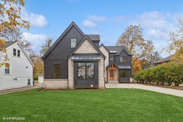 view of front of property with metal roof, a front lawn, a standing seam roof, and board and batten siding