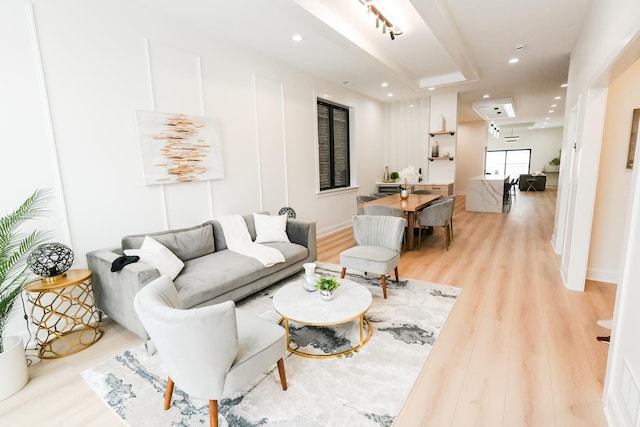 living area featuring light wood-style flooring and recessed lighting