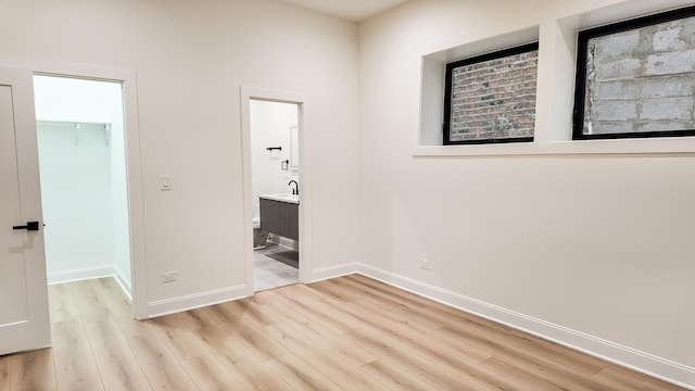 spare room with light wood-style floors and baseboards