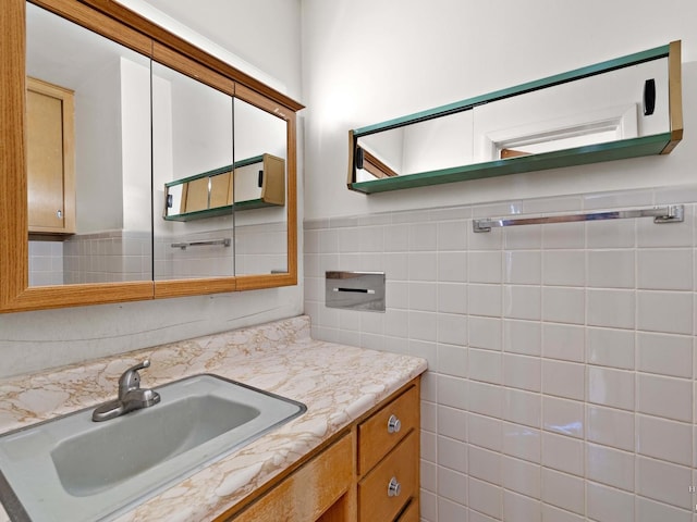 bathroom featuring wainscoting, vanity, and tile walls