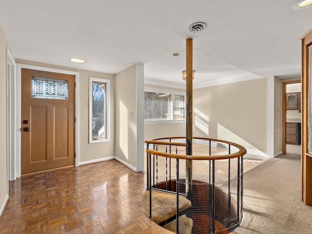 entrance foyer with baseboards and visible vents