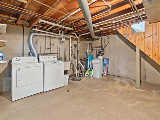 unfinished below grade area featuring washing machine and dryer