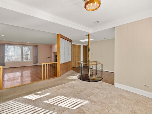 unfurnished room with ornamental molding, a fireplace, and baseboards