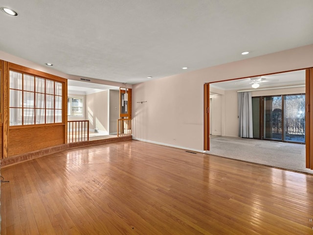 spare room with recessed lighting, baseboards, and wood finished floors