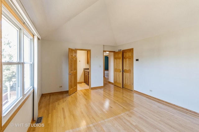 unfurnished bedroom with light wood-style floors, visible vents, baseboards, and multiple windows