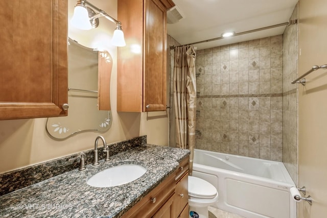 full bath with visible vents, vanity, toilet, and shower / bath combo with shower curtain