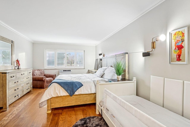 bedroom with a wall mounted AC, light wood-type flooring, and crown molding