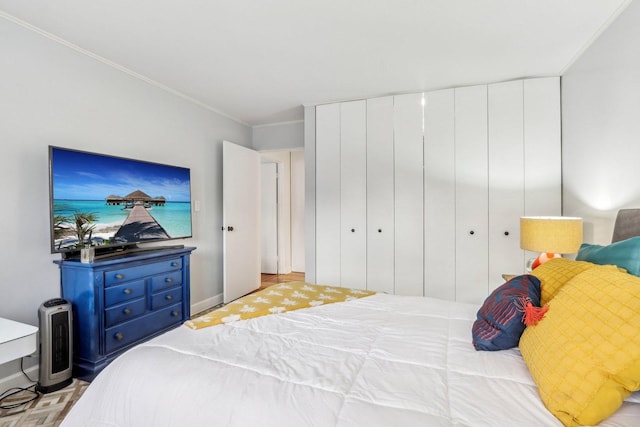 bedroom featuring a closet and crown molding