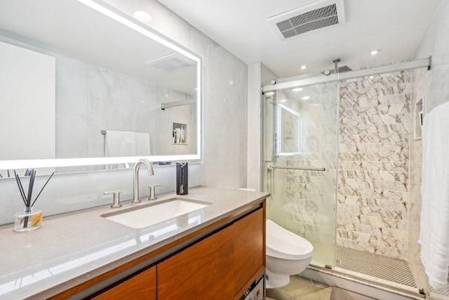 full bath with a stall shower, visible vents, vanity, and toilet