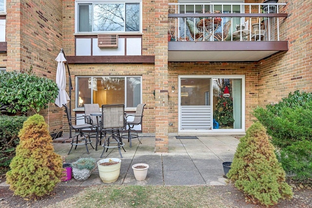 view of patio featuring outdoor dining area and a balcony