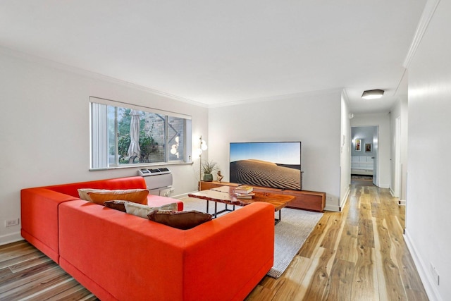 living area with crown molding, light wood-style flooring, and baseboards