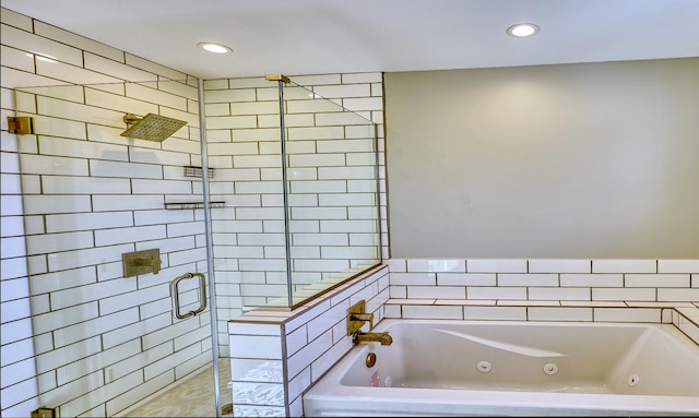 full bathroom with recessed lighting, a jetted tub, and a shower stall