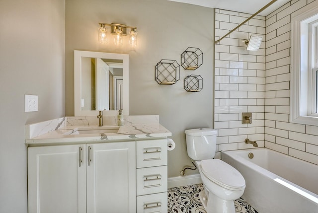 bathroom with bathtub / shower combination, baseboards, vanity, and toilet