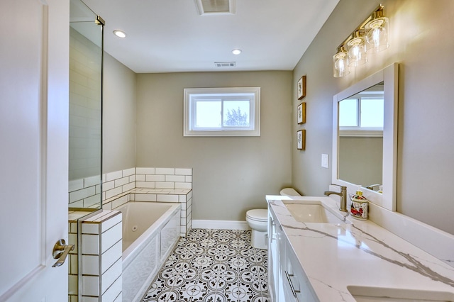 bathroom featuring a sink, a healthy amount of sunlight, double vanity, and a bath