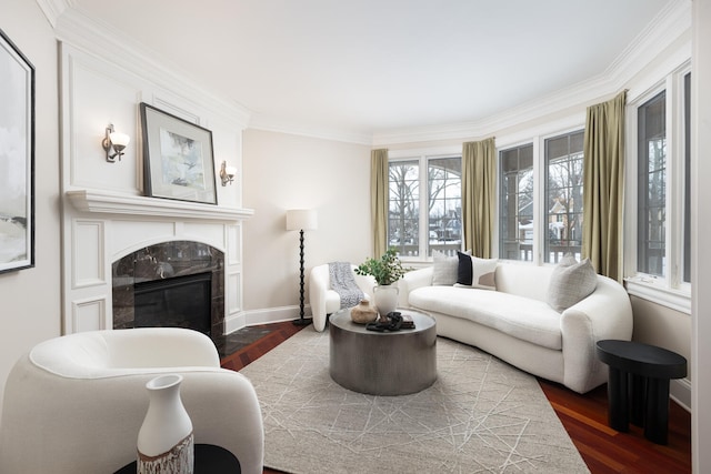 living room featuring ornamental molding, dark wood-style flooring, a high end fireplace, and baseboards