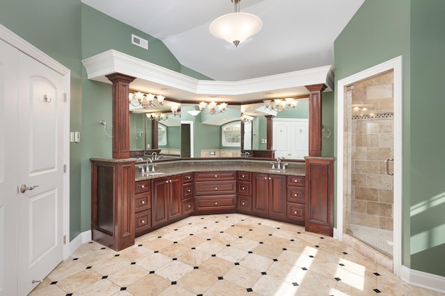 bathroom with double vanity, a stall shower, decorative columns, and visible vents